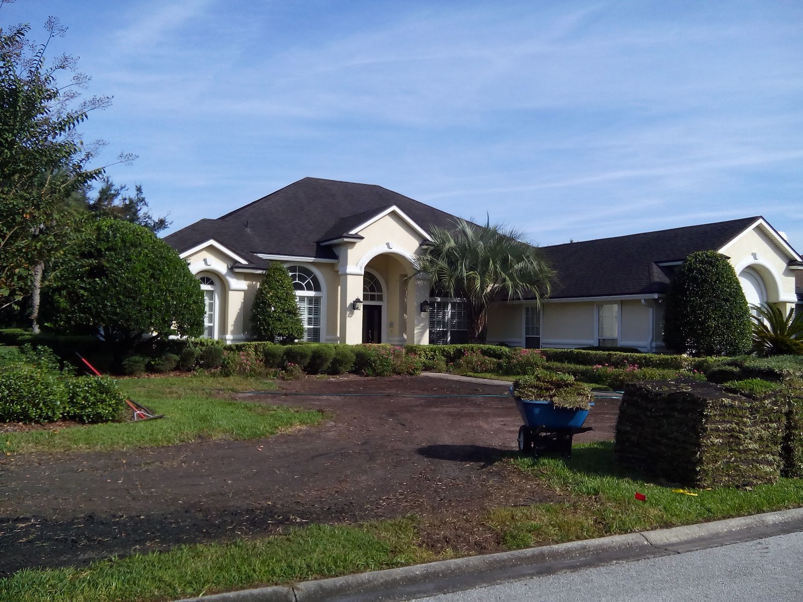 Sod stacked and soil prepped for a lawn repair